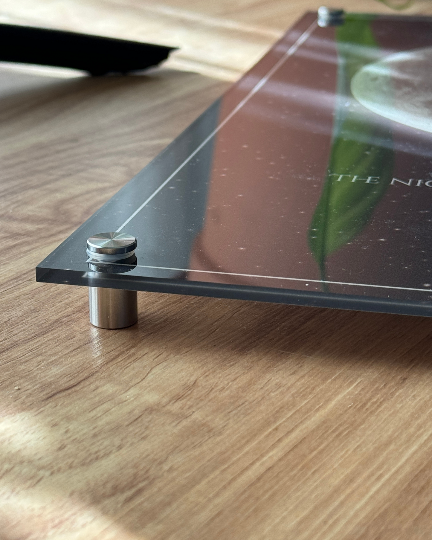 Single moon phase acrylic portrait print in a black frame, showcasing a dark and neutral color palette