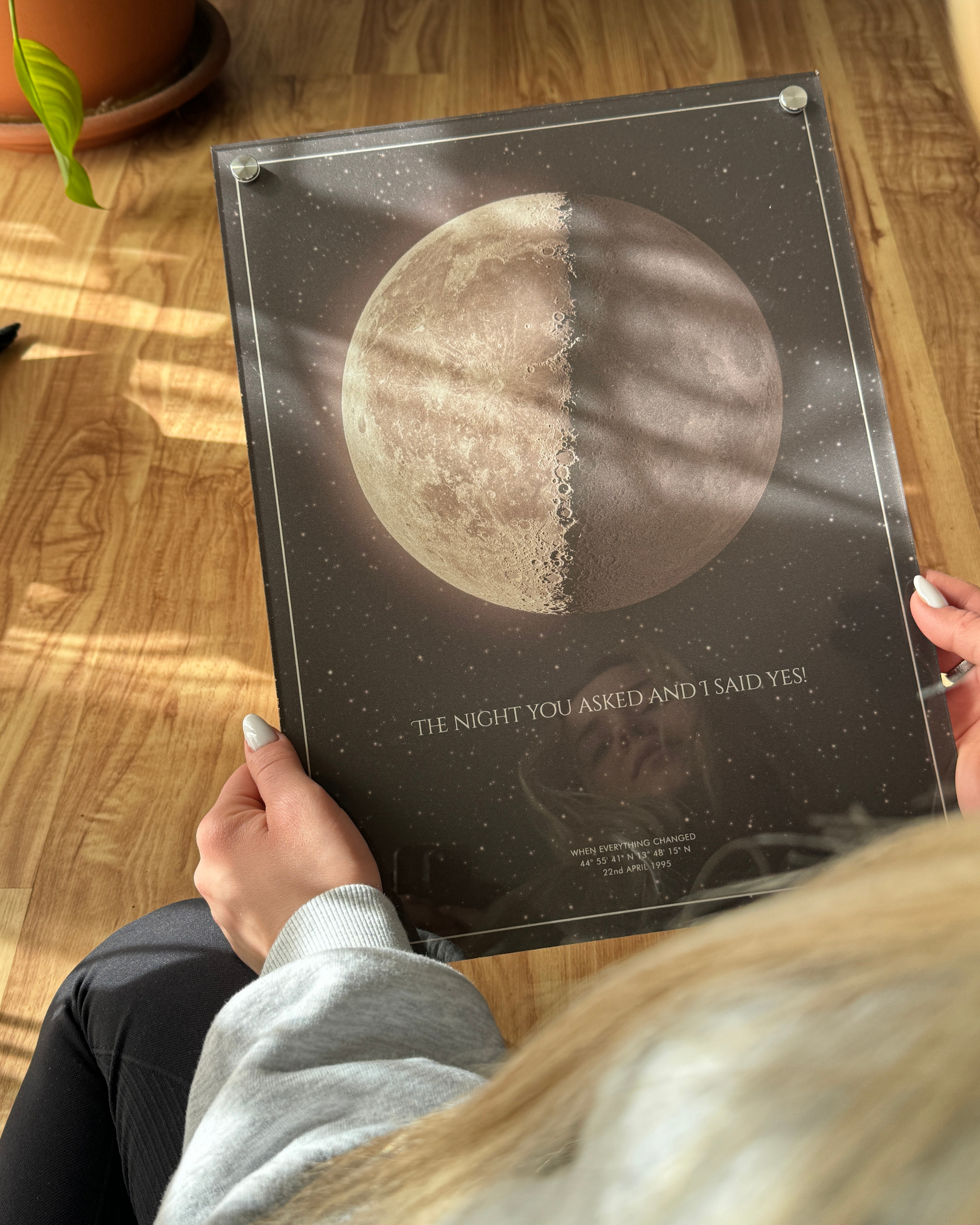 Single moon phase acrylic portrait in warm tones featuring a dark background and rich red-orange hues