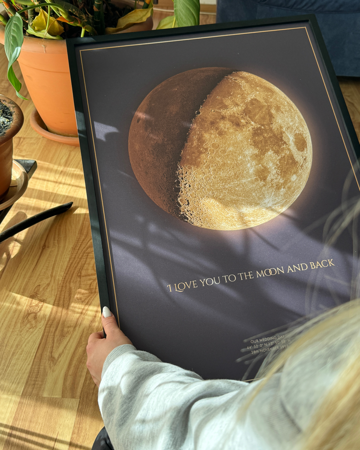Single moon phase wall art in a black frame, featuring a dark neutral tone and minimalist style